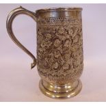 A foreign silver coloured metal tankard of baluster form,