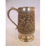A foreign silver coloured metal tankard of baluster form,