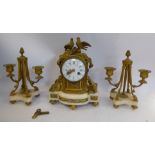 A mid 19thC French gilt metal and white onyx cased clock garniture, surrounded by a torch,