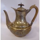 A late Victorian silver hot water pot of squat,