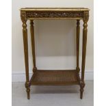 A late 19thC Continental giltwood occasional table with a mottled grey marble top, raised on turned,