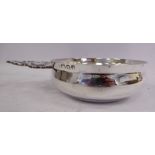 A silver wine taster of oval form with a flared rim and a decoratively pierced tab handle