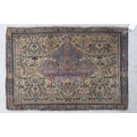 A Persian rug with a central serpentine outlined diamond shaped motif,