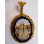 A late 19thC oval gilt metal pendant with applied wire ornament, set with a micromosaic tablet,