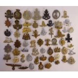 Approx fifty military cap badges and other insignia,