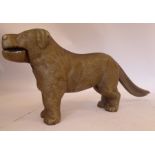 An early 20thC silver painted cast iron novelty nutcracker, in the form of a standing dog,