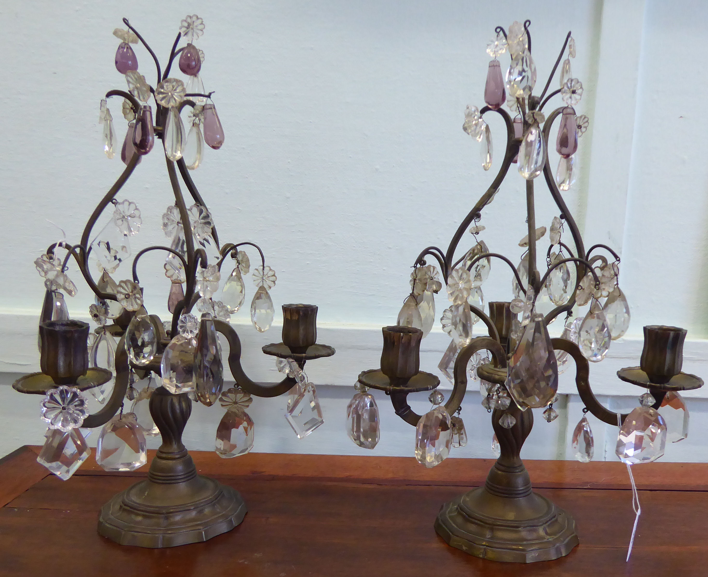 A pair of early 20thC brass table candelabra, comprising three scrolled branches,