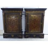 A pair of late 19thC French black lacquered and ormolu mounted side cabinets with red boulle worked