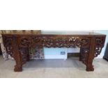 A 20thC Chinese elm altar table, having a mitred and panelled top,