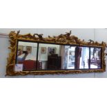 A mid 19thC mahogany mirror, comprising three in-line plates,