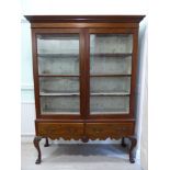 An early 19thC mahogany display cabinet, the level cornice with a dentil moulded frieze,