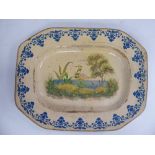 An early 19thC Continental slip glazed earthenware dish of elongated octagonal form,
