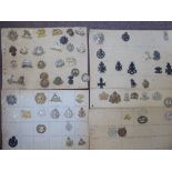 Approx sixty military cap badges and other insignia,