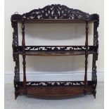 19thC mahogany three tier, hanging bow front shelves with fretworked flanks,