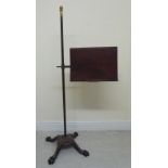 A late Victorian freestanding lectern, the mahogany platform with a paper restraint,