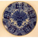 An early 19thC Dutch Delft dish, decorated in blue and white with geometric floral designs 8.