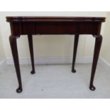 A George III mahogany tea table, the foldover top having turreted corners,