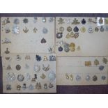 Approx sixty military cap badges and other insignia,