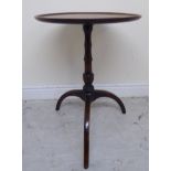 An early 19thC mahogany pedestal table, the turned top with a raised border,