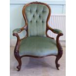 A late Victorian carved and moulded walnut showwood framed spoonback chair with open arms on