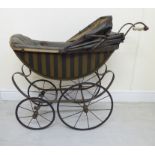 A late Victorian painted wooden dolls pram with a retractable canopy and a grey hide upholstered