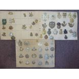 Approx sixty military cap badges and other insignia,