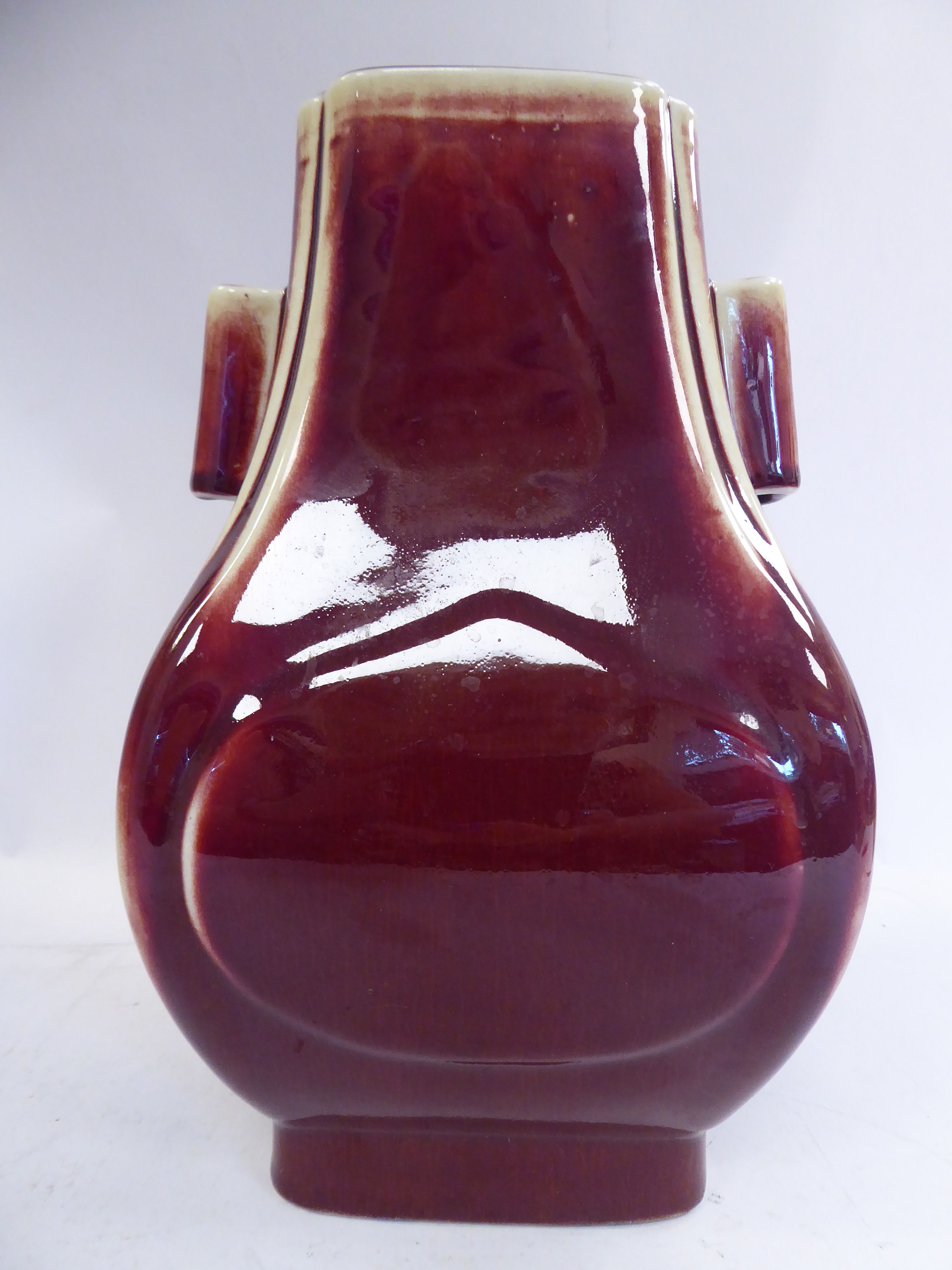 A 20thC Chinese 'rubbed' sang de boeuf glazed porcelain bulbous vase of panelled,