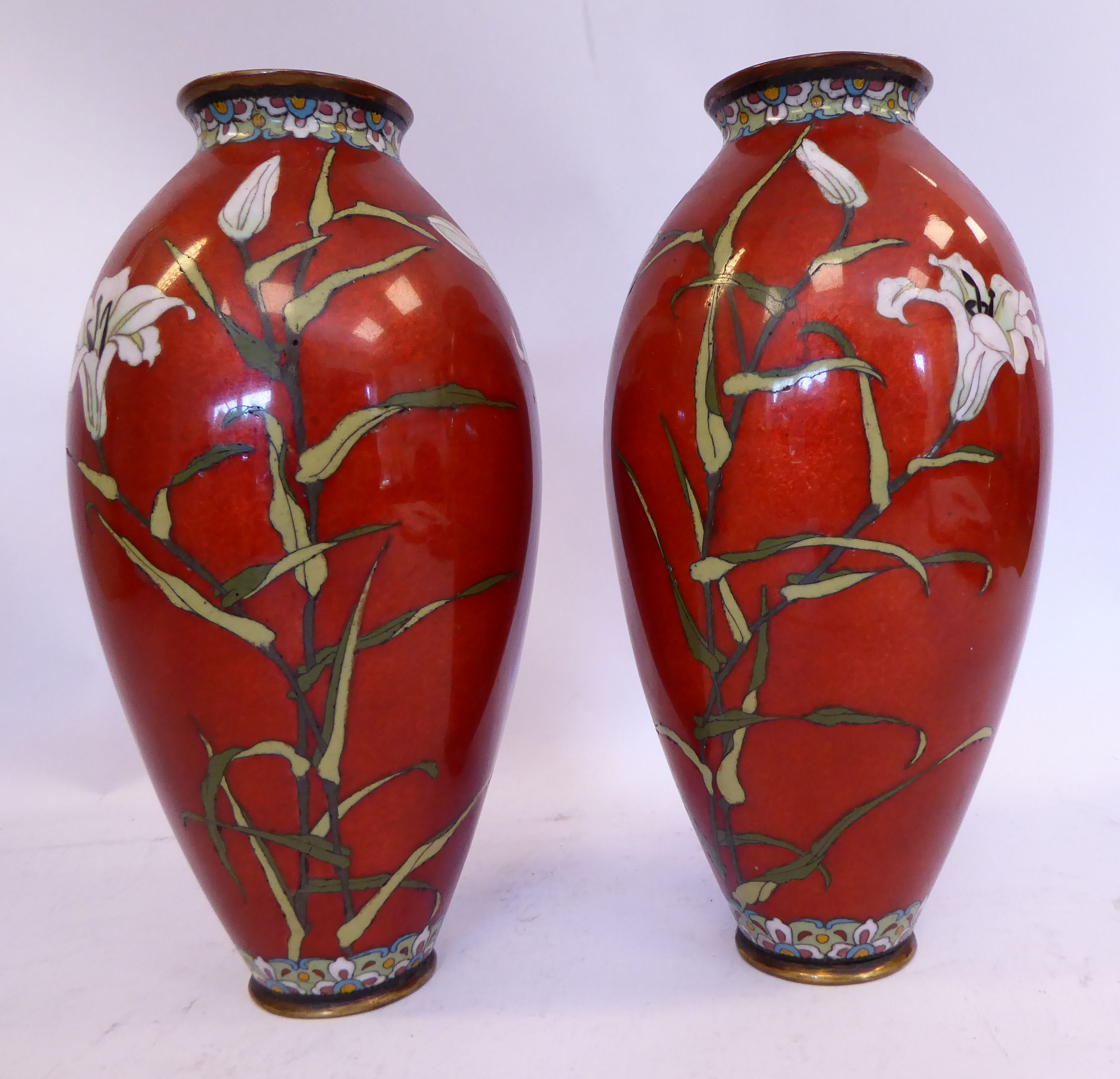 A pair of early 20thC Japanese cloisonne vases of ovoid form, decorated with flora,