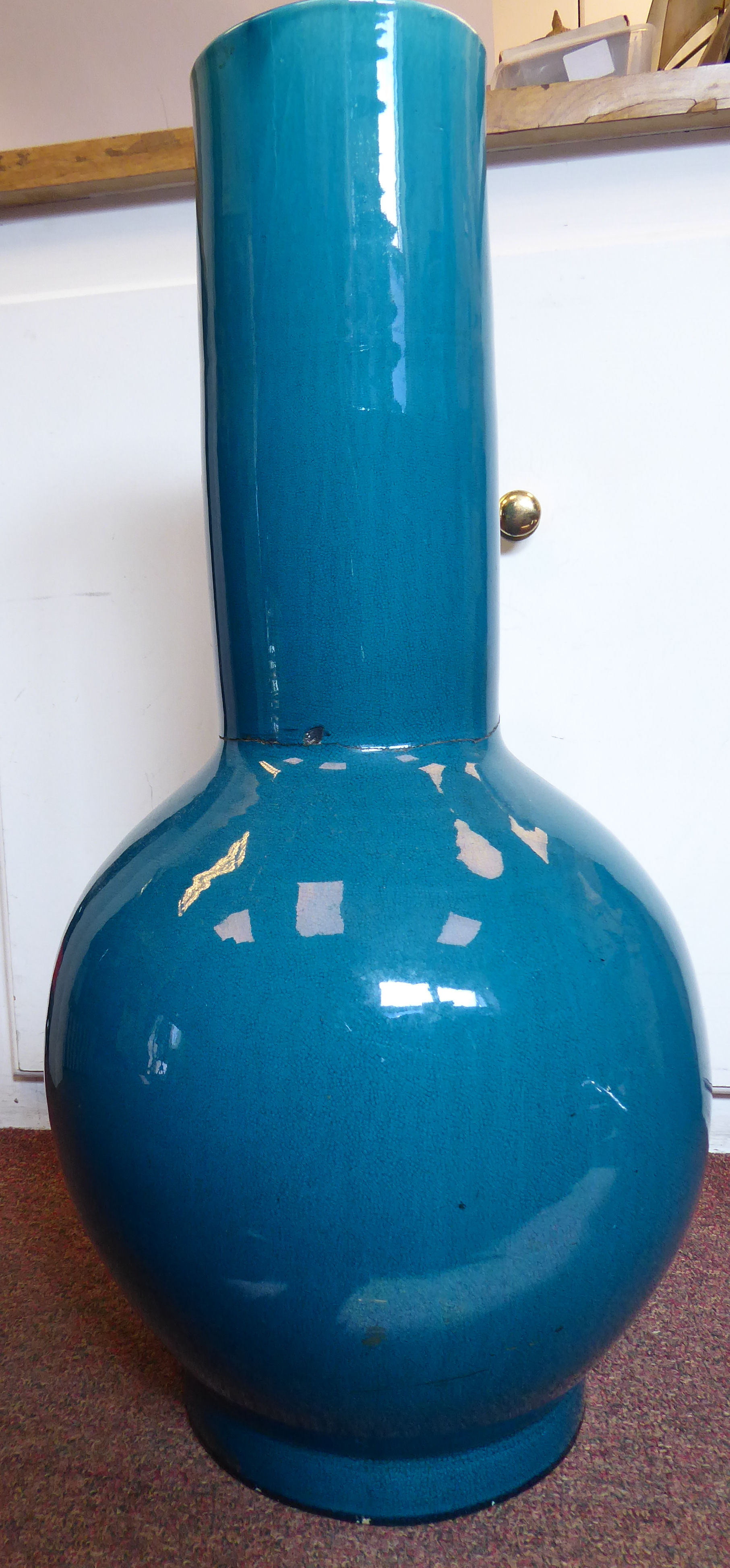 A 20thC Chinese turquoise glazed porcelain bulbous bottle vase with a long, wide, straight neck 25.