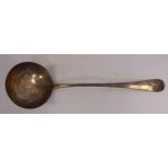 An Edwardian silver Hanoverian rattail pattern soup ladle with a round bowl and an engraved