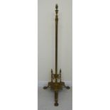 An early 20thC Empire style lacquered brass lamp standard, the reeded column set on a triform base,