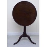 An early 19thC mahogany pedestal table, the turned top with an upstand border,