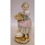A 19thC Meissen porcelain figure, a little girl holding a bird cage, standing on a stepped,