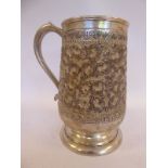 A foreign silver coloured metal tankard of baluster form,