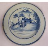 A late 18thC Chinese porcelain broad rimmed plate, decorated in blue and white with a building,