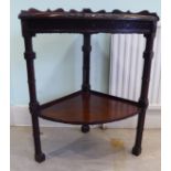A late 19thC Chippendale inspired, mahogany two tier quadrant table with relief,