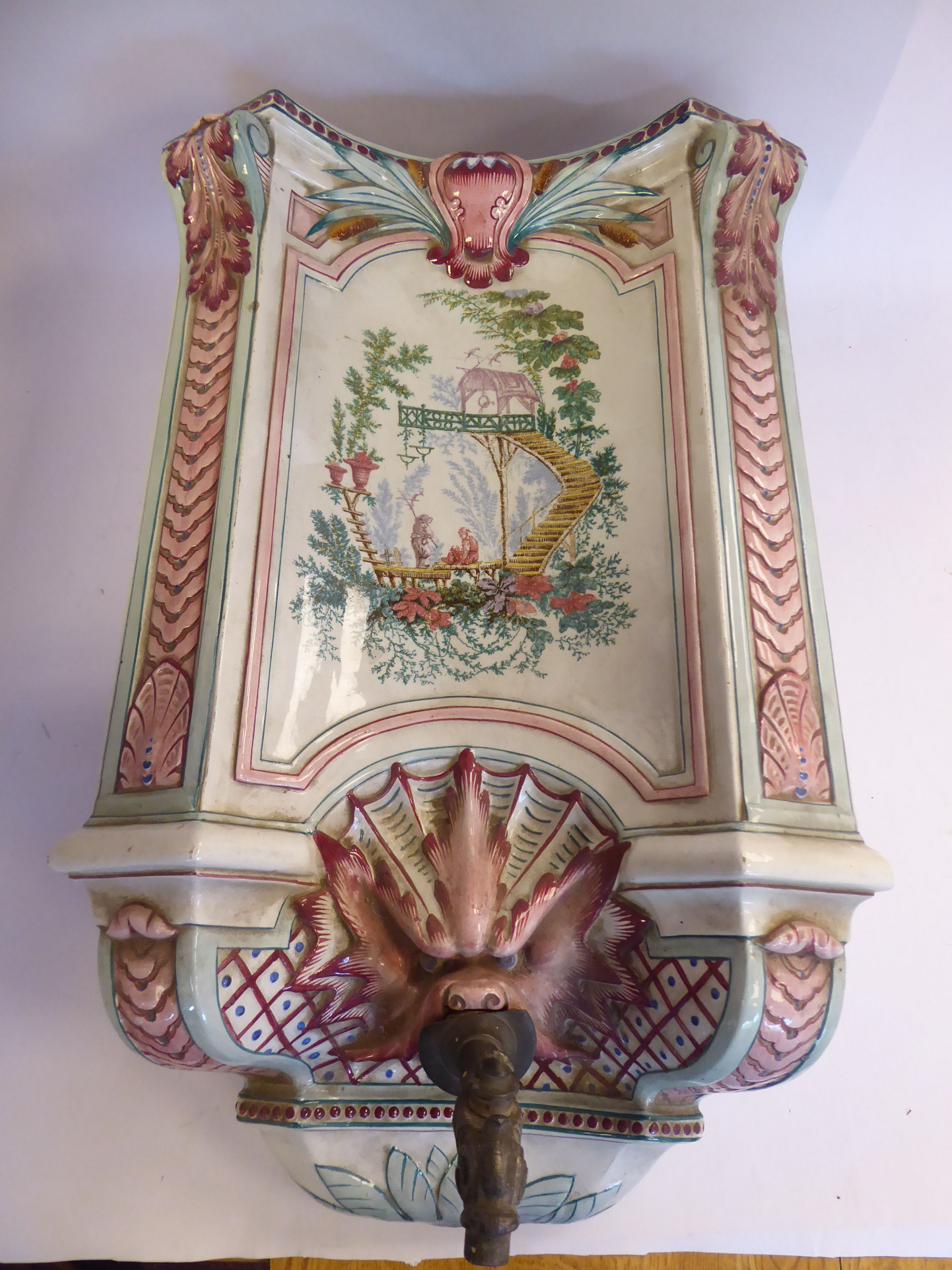 A late 19thC Sarreguemines moulded stoneware hanging cistern of incurved box design,