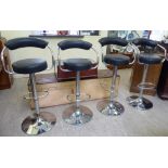 A set of four modern chromium plated tubular steel framed and faux chocolate brown hide upholstered,