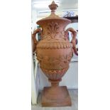 A terracotta finished, twin handled terrace urn of bulbous form, decorated with moulded, trailing,