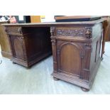 A late Victorian/Edwardian carved oak desk,