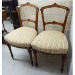 A pair of late Victorian walnut finished bar back bedroom chairs,