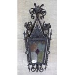 A late 19th/early 20thC black painted and foliate decorated scrolled wrought iron hall lantern with