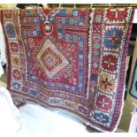 A Persian rug with three diamond shaped motifs,