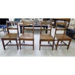 A set of four early 19thC country made oak framed chairs with horizontal bar crests and splats,