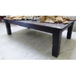 A modern rustically constructed, dark stained oak coffee table,