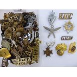 An uncollated collection of military and associated cap badges and emblems: to include Royal