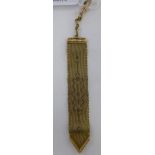 A yellow metal bookmark,