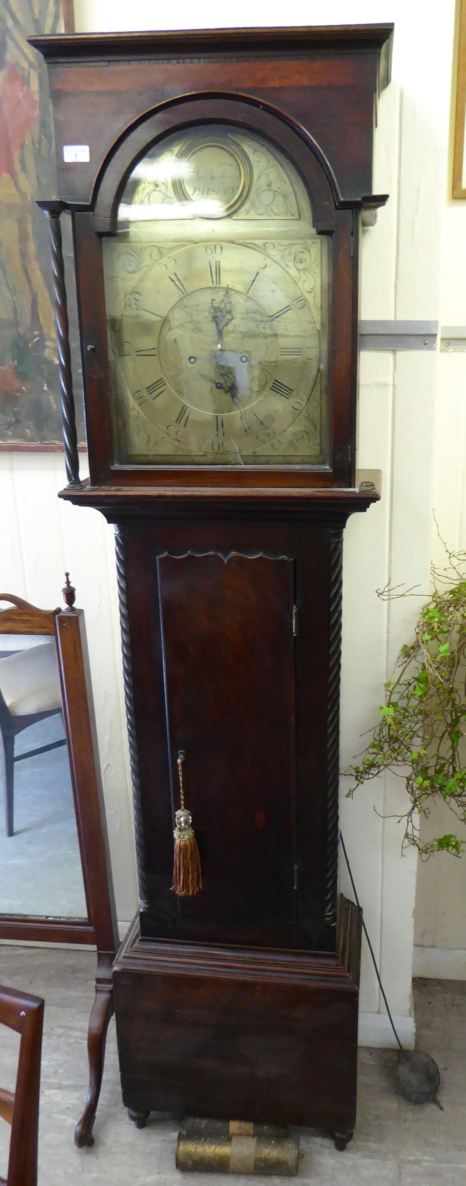 An early 19thC mahogany longcase clock, the hood with a level top, over an arched window,