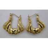 A pair of yellow metal, hollow hoop earrings,