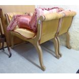 A pair of modern stained beech Regency design window seats, each with a scrolled end,